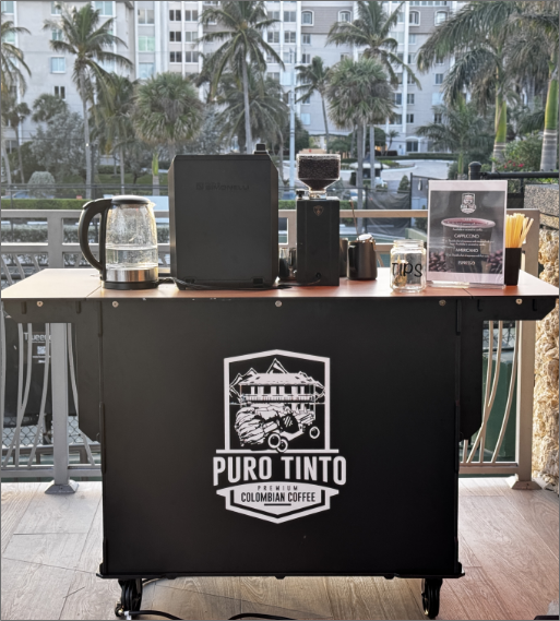 Puro Tinto's mobile coffee cart fully equipped for events, showing kettle, grinder, and branding at an outdoor venue